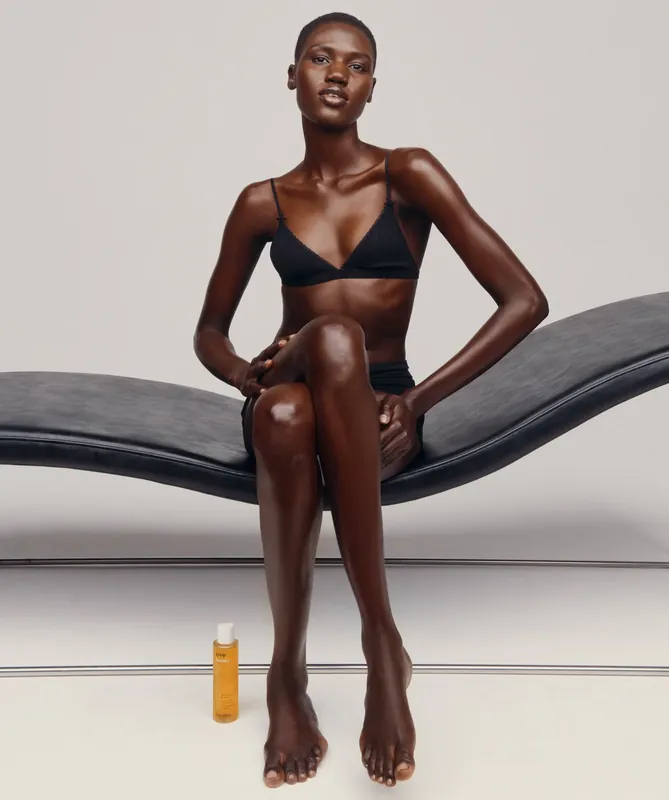 Beauty studio portrait, seated on a black chaise